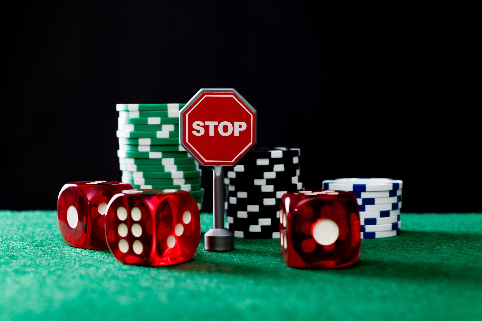 Gambling chips and stop sign on the table