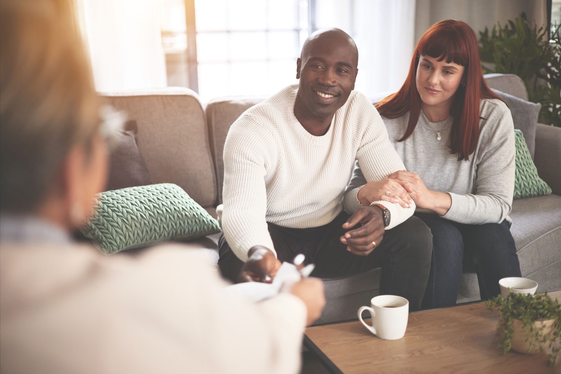 A couple and psychologist, financial advisor or therapist, meeting to talk money matters. A young man and woman talking with a counsellor