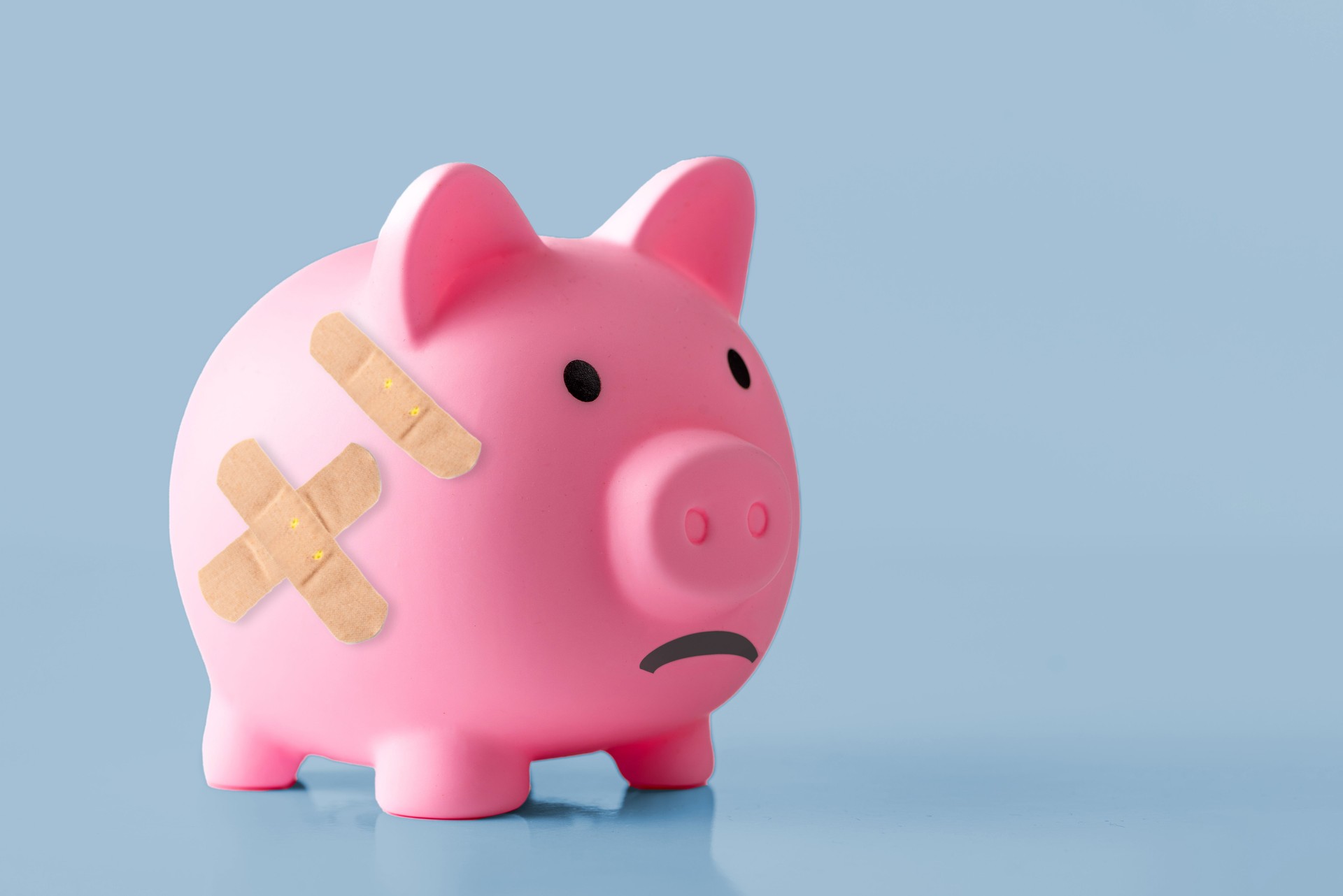 Piggy bank with a Band-Aid on it